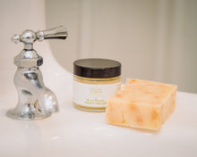 The best face moisturizer for dry skin, Willow & Birch Apothecary’s Sweet Dreams Night Cream, is shown at a bathroom sink, alongside a natural soap, embodying an anti-aging night cream ritual.