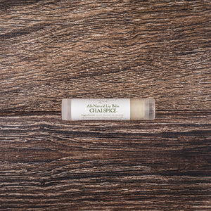 Chai Spice natural lip balm tube against a wooden backdrop, embodying the best lip balm for dry lips with cocoa butter lip therapy for daily chapstick  lip butter balm use.