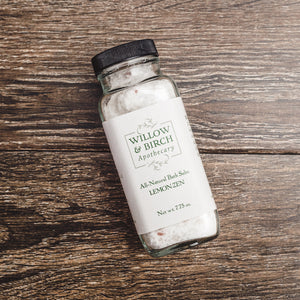 Willow and Birch Apothecary’s Lemon Zen natural bath salts, showcasing the best bath salts for relaxing, captured on a textured wooden surface, highlighting Epsom salt uses in a spa bath setting.