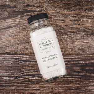 Willow and Birch Apothecary’s Orange Spice epson salt, artfully placed on a wooden table, showcasing the soothing qualities of spa bath salts and the best bath crystals for a calming spa experience.