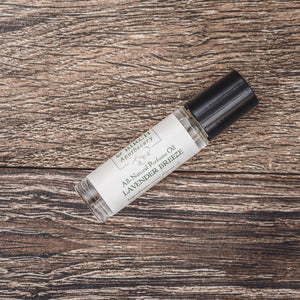 Lavender Breeze natural perfume presented by Willow & Birch Apothecary on a wooden surface, for those seeking a subtle and non toxic perfume or body oil perfume.