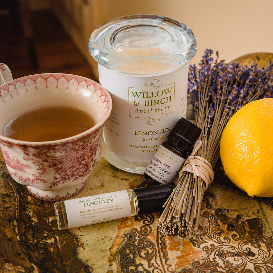 Lemon Zen scented natural artisan bath, beauty, and fragrance by Willow & Birch Apothecary pictured with antique teacup, fresh lemon, and lavender bouquet, inspired by Downton Abbey and English garden style, vintage victorian style for the old soul