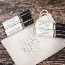 A collection of all natural perfume oils including English Fog, Orange Spice, Lavender Breeze, and Lemon Zen, presented with a Willow & Birch Apothecary pouch.