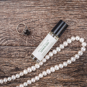 Lemon Zen all natural perfume oil framed by elegant pearls, embodying Willow & Birch Apothecary's commitment to non toxic perfume and signature scent offerings.