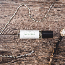 Orange Spice essential oil perfume alongside vintage pearl jewelry, showcasing a luxurious natural perfume fragrance option from Willow & Birch Apothecary.